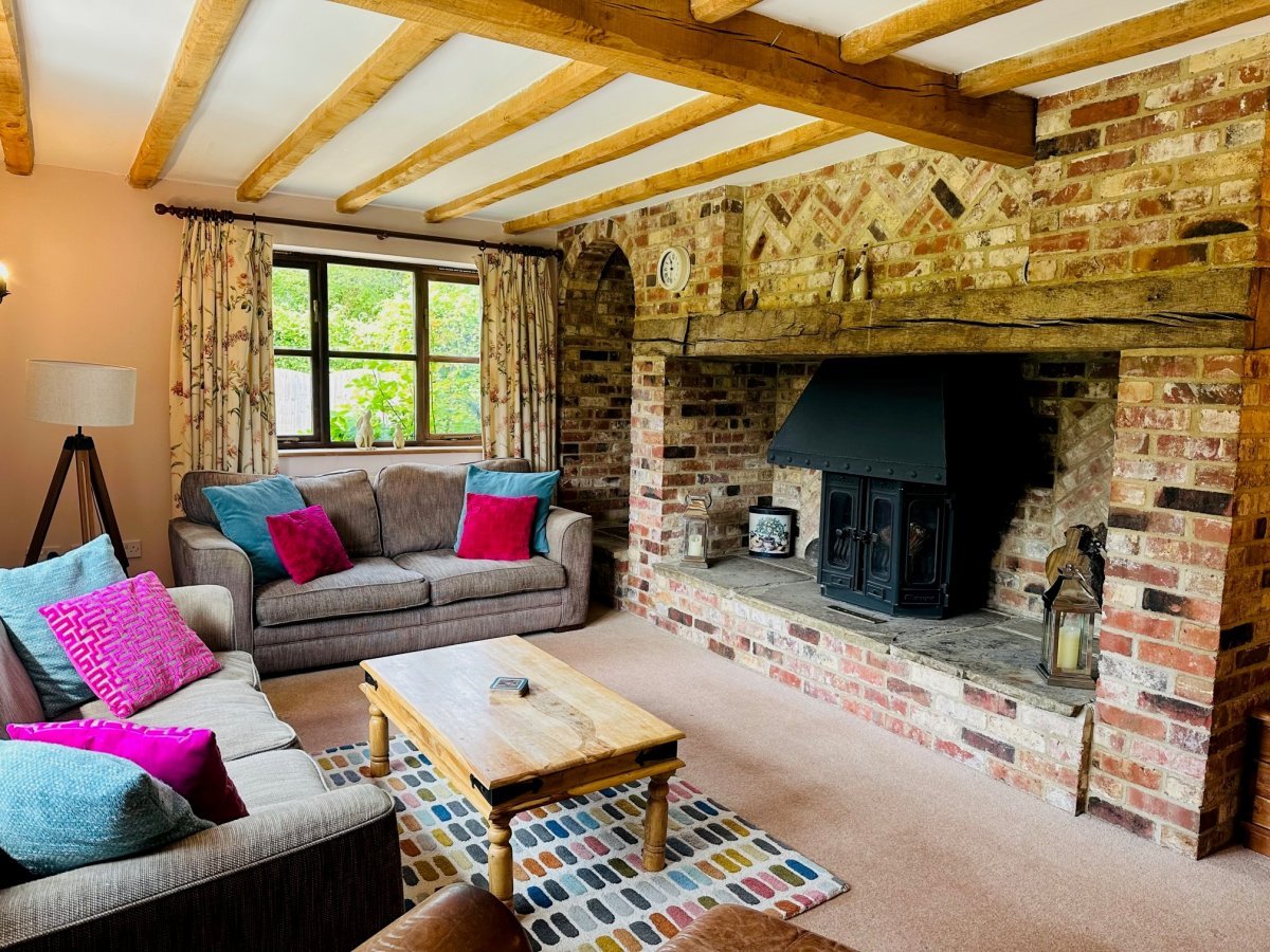 Ashford Farm - Turkey House sleeping 7 - cosy sitting room with a wood burner